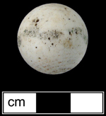 Unglazed porcelain marble with painted bull’s eye and repeating leaf pattern motif around the circumference. Similar marbles have been found in archaeological contexts dating c. 1850-1860 (Carskadden and Gartley 1990). The painted motif is almost entirely worn off of this porcelain marble - Click images for larger view. 